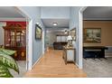 Inviting hallway with hardwood floors leading to a living room and formal dining room featuring beautiful decor at 15 Smoketree Ct, Durham, NC 27712