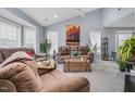 Bright living room featuring plush sofas, a vaulted ceiling, and neutral gray walls at 1516 Greys Mill Rd, Rocky Mount, NC 27804