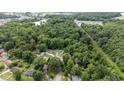 Wide aerial shot displaying the neighborhood, highlighting the home's location and surrounding nature at 1713 Elder Ct, Burlington, NC 27215