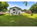 View of the expansive backyard with lush green grass and mature trees creating a private oasis at 1713 Elder Ct, Burlington, NC 27215
