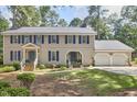 Traditional two-story home with blue shutters, double front doors, and a two-car attached garage at 1913 Fawndale Dr, Raleigh, NC 27612