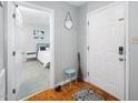 Inviting entryway with hardwood floors, a neutral color scheme, and a glimpse into a cozy bedroom at 213 Bracken Ct, Raleigh, NC 27615