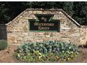 Stone community entrance sign that reads Waterford Green with beautiful flower bed at 2302 Fordcrest Dr, Apex, NC 27502