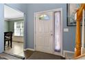 Bright entry way with tiled floors, natural light, and view into the dining area at 2302 Fordcrest Dr, Apex, NC 27502