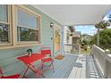 Relaxing front porch featuring a charming red table and chairs, ideal for enjoying your morning coffee at 2322 Stroller Ave, Durham, NC 27705