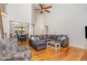 Bright and airy living room with high ceilings, hardwood floors, and large sectional sofa at 240 Oak Grove Church Rd, Youngsville, NC 27596