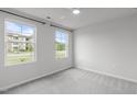 Bright bedroom with large windows offering great light and neutral decor creating a calming space at 2539 Kasota Ln, Raleigh, NC 27610