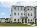 Well-maintained two-story townhouse with neutral siding, manicured landscaping, and welcoming front entries at 2539 Kasota Ln, Raleigh, NC 27610