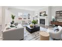 Cozy living room featuring a fireplace, large windows, and modern furnishings, creating an inviting atmosphere at 2613 Red Spruce Dr, Raleigh, NC 27616