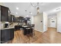 Modern kitchen with stainless steel appliances, dark cabinetry, and granite countertops at 2904 Britmass Dr, Raleigh, NC 27616