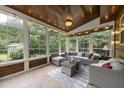 Bright sunroom with tile flooring, wood ceiling, and comfortable seating area at 2904 Britmass Dr, Raleigh, NC 27616