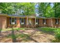 Inviting brick home featuring a classic front porch with columns and dark shutters against the windows at 3006 Pump Station Ln, Durham, NC 27712