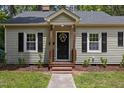 Attractive home with manicured lawn, black shutters, and a decorative wreath at 308 Greenwood Dr, Durham, NC 27704