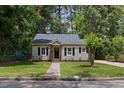 Charming single-story home featuring a landscaped yard and inviting front porch at 308 Greenwood Dr, Durham, NC 27704