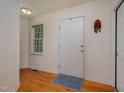 Bright entryway featuring hardwood floors, a front door, and a window at 313 Teresa Dr, Rolesville, NC 27571