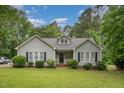 Inviting single-story home with a green lawn and blooming bushes at 313 Teresa Dr, Rolesville, NC 27571