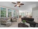 Cozy living room with large windows providing natural light and views into the kitchen at 317 Chanticlair Dr, Apex, NC 27502