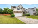 Two-story home with a two-car garage, well-kept lawn, and inviting front porch at 326 Hope Valley Rd, Knightdale, NC 27545