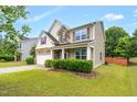 Two-story home with front lawn and landscaping at 326 Hope Valley Rd, Knightdale, NC 27545