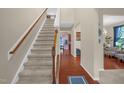 Inviting home foyer featuring a staircase with carpeted steps and hardwood floors at 326 Hope Valley Rd, Knightdale, NC 27545