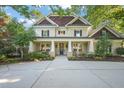 Charming two-story home featuring elegant columns, rocking chairs, and a welcoming entryway at 3324 Thomas Rd, Raleigh, NC 27607