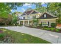 Beautiful two-story home with mature trees, manicured landscaping and a concrete driveway at 3324 Thomas Rd, Raleigh, NC 27607