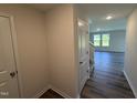 Inviting hallway featuring wood-style flooring, leading to a brightly lit living space at 37 Chloe Ct, Selma, NC 27576