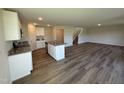 Modern kitchen features granite countertops, white cabinets, stainless steel appliances, and an island at 37 Chloe Ct, Selma, NC 27576