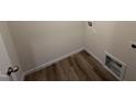 A compact laundry area with hookups and durable luxury vinyl plank flooring at 37 Chloe Ct, Selma, NC 27576