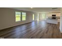 Spacious living area with wood flooring, natural light, and seamless flow into the kitchen at 37 Chloe Ct, Selma, NC 27576