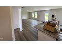 Open concept living area offering neutral walls, luxury vinyl plank flooring, and natural light at 37 Chloe Ct, Selma, NC 27576