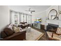 Inviting living room featuring a fireplace, stylish decor, and large windows for ample natural light at 4413 Sugarbend Way, Raleigh, NC 27606