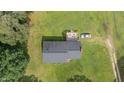 Aerial view of a quaint home with a backyard deck, surrounded by lush greenery at 445 Lee County Line Rd, Broadway, NC 27505