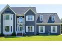 The exterior of a two-story home is shown with gray siding and white trim at 5013 Wheatridge Dr, Fuquay Varina, NC 27526