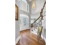 The foyer boasts hardwood floors, stairs, a chandelier, and a decorative front door at 5013 Wheatridge Dr, Fuquay Varina, NC 27526