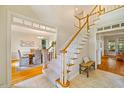 Inviting foyer showcasing a staircase and an entrance to the dining room with hardwood floors at 5205 Coffeetree Dr, Raleigh, NC 27613