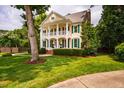 Charming two-story home with a classic design, featuring a well-kept lawn and mature trees at 5205 Coffeetree Dr, Raleigh, NC 27613
