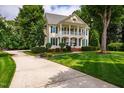 Beautiful two-story house boasting a welcoming front porch, complemented by a well-manicured lawn at 5205 Coffeetree Dr, Raleigh, NC 27613