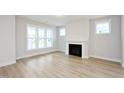 Bright and airy living room featuring a fireplace and light wood flooring at 524 Folk Song Way, Wendell, NC 27591