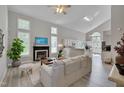 Bright living room with vaulted ceilings, fireplace, large windows, and open concept kitchen at 5308 Bentgrass Dr, Raleigh, NC 27610