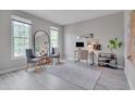 Bright home office featuring hardwood floors, modern furnishings, and plenty of natural light at 5308 Bentgrass Dr, Raleigh, NC 27610