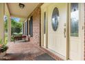 Inviting front porch with brick flooring, decorative front door, and space for relaxing seating at 658 Hiawatha Pl, Burlington, NC 27217