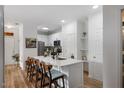 Stylish kitchen with an island breakfast bar, stainless steel appliances, and sleek white cabinetry at 800 Savannah Ridge Rd # 109, Holly Springs, NC 27540