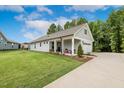 Beautiful single-story home showcasing lush landscaping and a covered front porch with seating at 8217 White Star Dr, Fuquay Varina, NC 27526