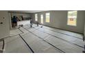Open living space with white kitchen cabinets and ample natural light at 88 W Emily Gardens Dr, Selma, NC 27576