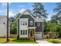 Charming two-story home with gray siding, white trim, a covered porch, and a well-maintained lawn at 905 Deboy St, Raleigh, NC 27606
