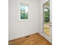 Bright interior room with hardwood floors, a window with a view, and a glass door to the outside at 905 Deboy St, Raleigh, NC 27606