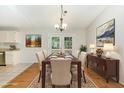 Elegant dining room with a wooden table, seating for six, and French doors to the backyard at 9709 Batesville Dr, Raleigh, NC 27617