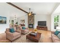 Bright and airy living room with a stone fireplace, hardwood floors, and comfortable seating at 9709 Batesville Dr, Raleigh, NC 27617