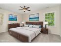 Cozy main bedroom featuring a large bed, ceiling fan, and bright windows for natural light at 9709 Batesville Dr, Raleigh, NC 27617